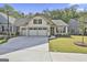Charming one-story home featuring a three-car garage, well kept lawn, and manicured landscaping at 430 Silverbell Ct, Peachtree City, GA 30269
