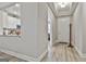 Hallway with light walls and wood flooring that flows into the kitchen and front door at 430 Silverbell Ct, Peachtree City, GA 30269