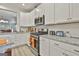Updated kitchen boasts white cabinets, stainless appliances, and granite countertops at 430 Silverbell Ct, Peachtree City, GA 30269