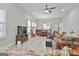 Open-concept living room with modern furnishings and wood-look floors flowing into a dining area at 430 Silverbell Ct, Peachtree City, GA 30269