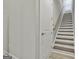 Bright staircase with wood treads and white risers leading to a window at 430 Silverbell Ct, Peachtree City, GA 30269