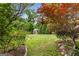 Manicured backyard with a storage shed and lush landscaping in a serene setting at 239 Kings Hwy, Decatur, GA 30030