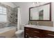 Bathroom with mosaic tile accent wall and wooden vanity at 239 Kings Hwy, Decatur, GA 30030