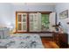 Bedroom featuring blue walls, hardwood floors, a fireplace, and large windows at 239 Kings Hwy, Decatur, GA 30030