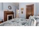 Cozy bedroom with a fireplace, hardwood flooring, and light blue walls at 239 Kings Hwy, Decatur, GA 30030