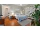 Bright bedroom features a cozy bed, hardwood floors, and plantation shutters at 239 Kings Hwy, Decatur, GA 30030