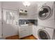 Convenient laundry room with stacked washer/dryer, white cabinets, and direct outdoor access at 239 Kings Hwy, Decatur, GA 30030