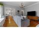 Inviting living room with hardwood floors, a gray sofa, and an open doorway to the kitchen at 239 Kings Hwy, Decatur, GA 30030