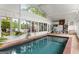 Indoor pool area with outdoor views, patio table, and chairs for lounging at 239 Kings Hwy, Decatur, GA 30030