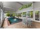 Relaxing indoor pool area with tiled flooring, many windows, and patio furniture at 239 Kings Hwy, Decatur, GA 30030