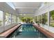 Bright indoor pool area featuring tiled trim, tile floors, and several windows at 239 Kings Hwy, Decatur, GA 30030