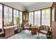 Bright sunroom with brick walls, decorative windows, and lots of plants at 239 Kings Hwy, Decatur, GA 30030