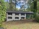 Two-story house with gray brick, black shutters, and a well-shaded front yard at 2851 Headland Dr, East Point, GA 30344