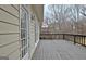 Spacious wooden deck offers ample outdoor living space with views of the surrounding trees at 112 Windalier Rdg, Peachtree City, GA 30269