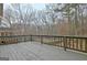 Large wooden deck offers a serene outdoor space with views of a wooded backyard at 112 Windalier Rdg, Peachtree City, GA 30269