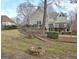 Large backyard features a fire pit, mature trees, and a home exterior with a deck at 112 Windalier Rdg, Peachtree City, GA 30269