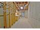 Unfinished basement featuring concrete walls, exposed beams, and utility connections at 112 Windalier Rdg, Peachtree City, GA 30269