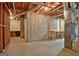 Unfinished basement space with exposed beams, concrete walls, and a concrete floor at 112 Windalier Rdg, Peachtree City, GA 30269