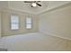 Bright bedroom featuring neutral walls, plush carpet, and tray ceiling with ceiling fan at 112 Windalier Rdg, Peachtree City, GA 30269