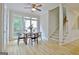 Bright dining area features hardwood floors, a modern ceiling fan, and a large window at 112 Windalier Rdg, Peachtree City, GA 30269