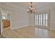 Spacious dining room with hardwood floors, plantation shutters, and an elegant chandelier at 112 Windalier Rdg, Peachtree City, GA 30269