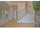 Inviting foyer showcasing hardwood floors, a staircase with wood railing, and natural light at 112 Windalier Rdg, Peachtree City, GA 30269