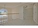 Hallway with vaulted ceilings, carpeted floors, and an arched window with lots of natural light at 112 Windalier Rdg, Peachtree City, GA 30269