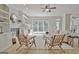 Light-filled living room featuring wood floors, built-in shelving, and large windows with a backyard view at 112 Windalier Rdg, Peachtree City, GA 30269