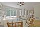 Bright living room featuring a ceiling fan, hardwood floors, and a large window overlooking the deck at 112 Windalier Rdg, Peachtree City, GA 30269