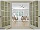 View of living room through glass doors showcasing bright interiors and backyard view at 112 Windalier Rdg, Peachtree City, GA 30269