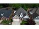 Aerial view of a well-maintained brick home with a dark roof and landscaped surroundings at 1880 Hickory Station Cir, Snellville, GA 30078