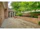 Backyard featuring a brick wall with stairs leading to a terraced garden at 1880 Hickory Station Cir, Snellville, GA 30078