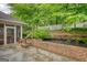 Landscaped backyard featuring a brick wall with stairs and lush greenery at 1880 Hickory Station Cir, Snellville, GA 30078