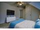 Staged bedroom with a TV, dresser, and bed, ideal for relaxation and entertainment at 1880 Hickory Station Cir, Snellville, GA 30078