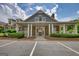 Inviting community clubhouse with stone accents, white pillars, covered porch, and ample parking at 1880 Hickory Station Cir, Snellville, GA 30078