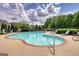 Relaxing community pool area with lounge chairs, a brick border, and mature trees for shade at 1880 Hickory Station Cir, Snellville, GA 30078