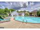 Spacious community pool with lounge chairs, surrounded by well-kept landscaping and neighborhood views at 1880 Hickory Station Cir, Snellville, GA 30078