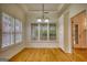 Bright dining room with hardwood floors, plantation shutters, and elegant lighting at 1880 Hickory Station Cir, Snellville, GA 30078