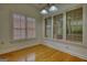 Dining area with hardwood floors and large windows offering abundant natural light at 1880 Hickory Station Cir, Snellville, GA 30078
