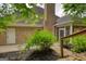 Exterior view of a brick home with a chimney, screened porch, and mature landscaping at 1880 Hickory Station Cir, Snellville, GA 30078