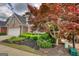 Brick home exterior showcases mature tree and well-maintained yard with a sprinkler system at 1880 Hickory Station Cir, Snellville, GA 30078