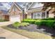 Exterior of a brick home boasting green landscaping and a white garage door at 1880 Hickory Station Cir, Snellville, GA 30078