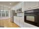 Modern kitchen boasts stainless steel appliances and sleek white cabinetry at 1880 Hickory Station Cir, Snellville, GA 30078