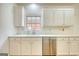 Kitchen with stainless steel dishwasher, white cabinetry, and tiled backsplash at 1880 Hickory Station Cir, Snellville, GA 30078
