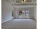 Spacious bedroom featuring neutral carpet, large windows offering views of the front, with an electrical outlet at 1880 Hickory Station Cir, Snellville, GA 30078