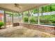 Screened patio with brick accents, a ceiling fan, and views of the landscaped yard at 1880 Hickory Station Cir, Snellville, GA 30078