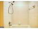 Detail of shower with white tile surround and adjustable shower head at 1880 Hickory Station Cir, Snellville, GA 30078
