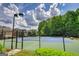 Well-maintained community tennis courts, fenced in, and surrounded by lush greenery at 1880 Hickory Station Cir, Snellville, GA 30078