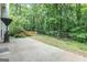 Backyard patio leading to fenced wooded area with trampoline at 2022 Maple Ridge, Acworth, GA 30101