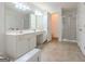 Primary bathroom featuring dual sinks, shower, and ample counter space at 2022 Maple Ridge, Acworth, GA 30101